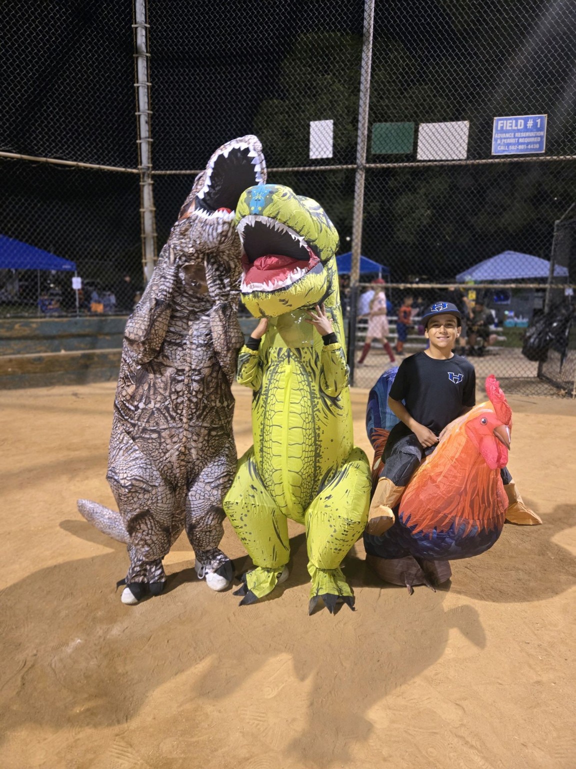 Dinosaur and chicken costumes during Trunk or Treat